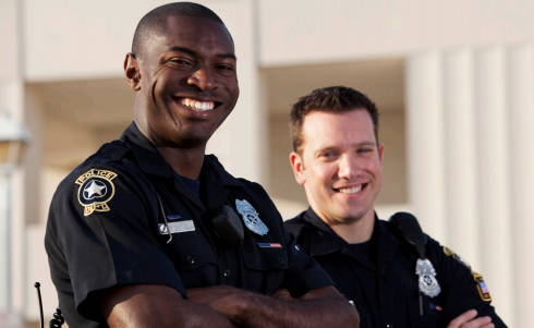 Two police officers smiling.